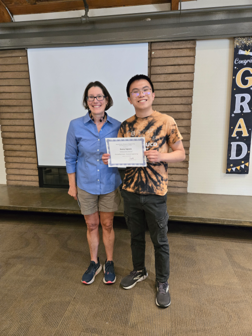Department Chair Dr. Kuhl presents the Chemical Engineering Outstanding Senior Award to Danny Nguyen